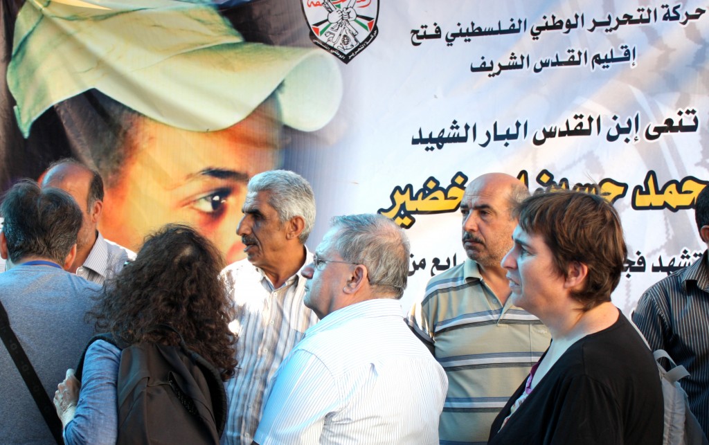 Members of the family of Muhammad Abu-Khdeir receive Israeli visitors who came to share in their grief in the Palestinian neighborhood of Shuafat in Jerusalem. The poster in the background reads: "The Palestinian National Liberation Movement, Fatah, Jerusalem area, mourns for the righteous son of Jerusalem, Muhammad Abu Khdeir, murdered as a martyr..."